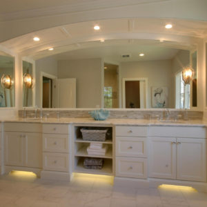 traditional master vanity with arched mirror and panelsweb
